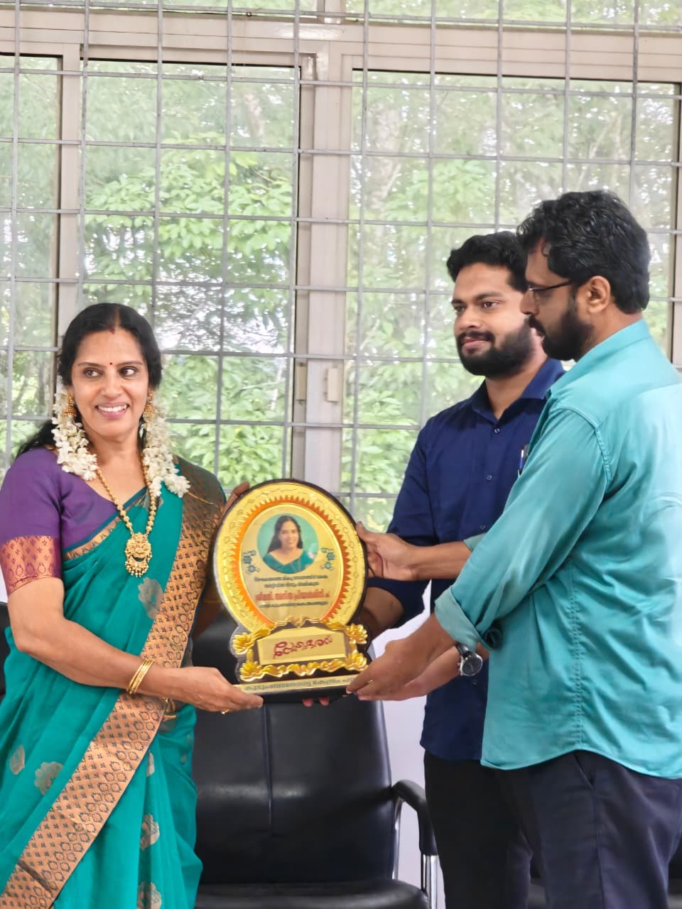 Mrs. Anithapriyadarsini S receiving recognition for her community service